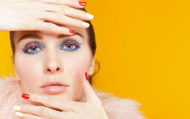 Experiment with eyeliner styles, like this woman's bright blue and pink eyeliner.