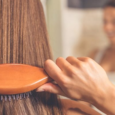how to straighten hair without heat woman brushing hair how to straighten hair without heat