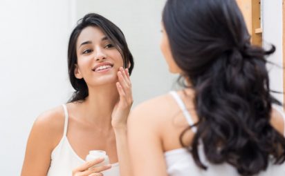 woman exfoliating face