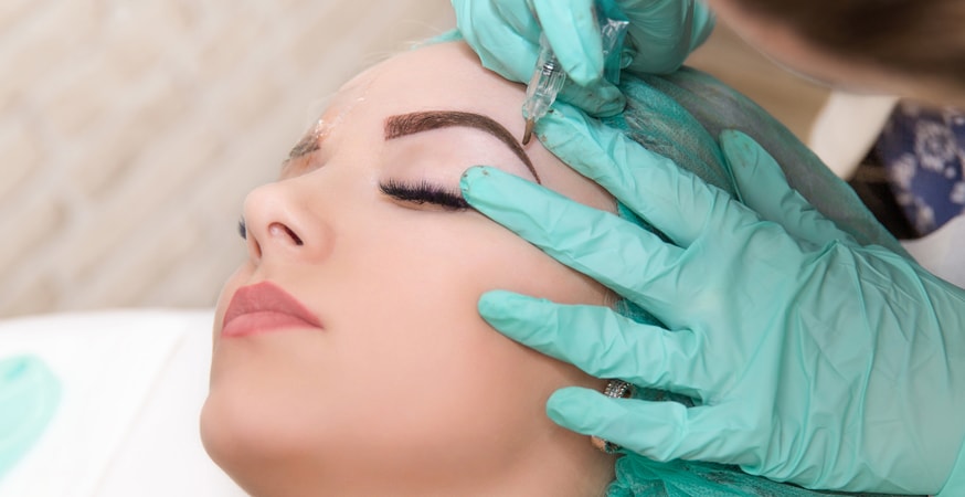 What is microblading? A woman geting microblading treatment done.