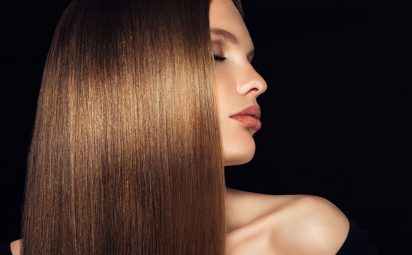 A woman has shiny, hydrated hair