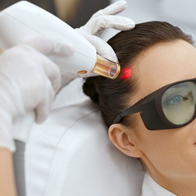 Laser Hair Growth Therapy: Does It Work? Woman receiving laser hair growth treatment