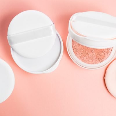 How to Clean Your BB Cushion Sponge in Seven Simple Steps BB cushion on a pink background with sponge and puff