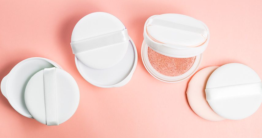 BB cushion on a pink background with sponge and puff