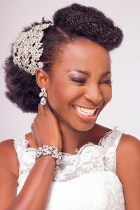 black woman in wedding dress and fancy updo smiling