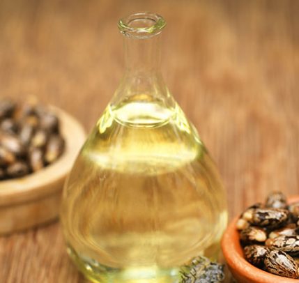 Everything You Need to Know About Using Castor Oil for Your Hair Castor beans and oil in a glass jar