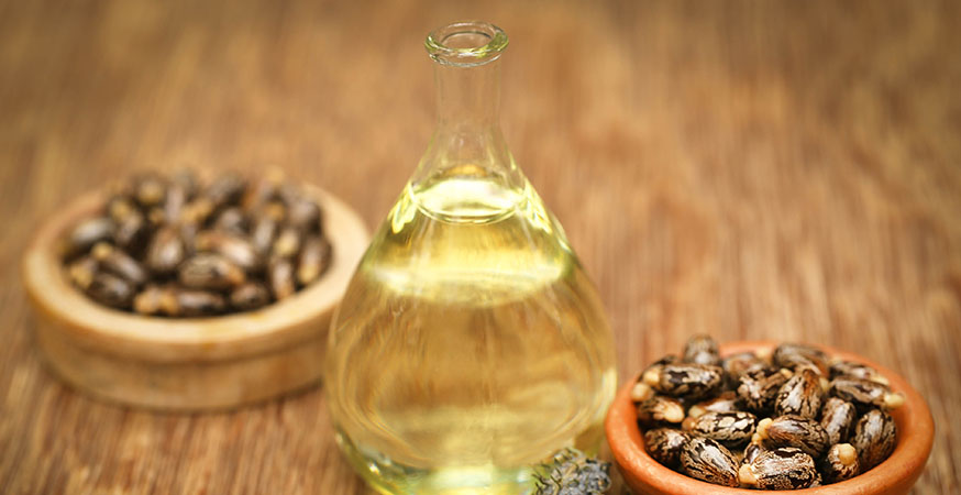 Castor beans and oil in a glass jar