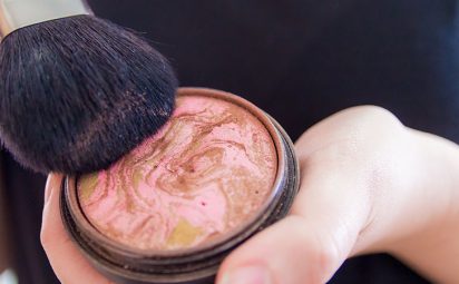 Close up of woman hands holding makeup bronzer