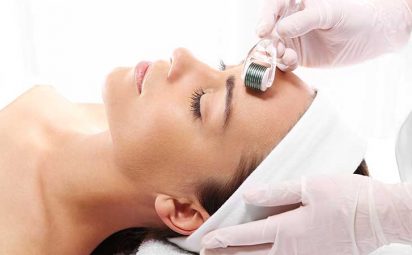 A woman getting a microneedling treatment done on her face