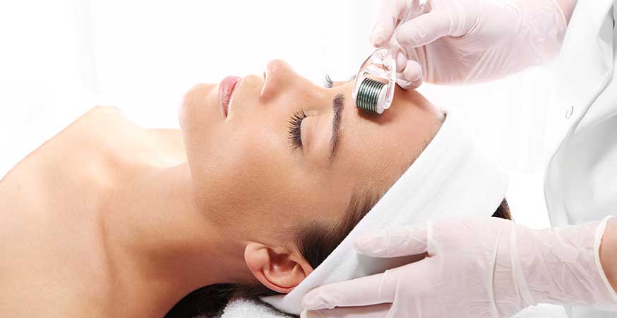 A woman getting a microneedling treatment done on her face