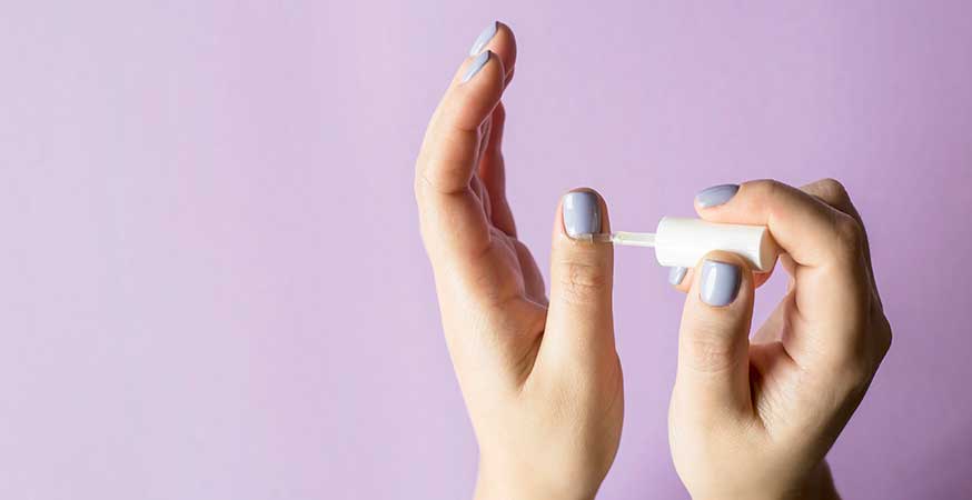 Applying cuticle oil to strengthen nails