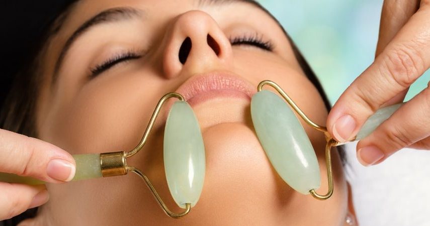 Somone is getting a jade facial roller treatment.