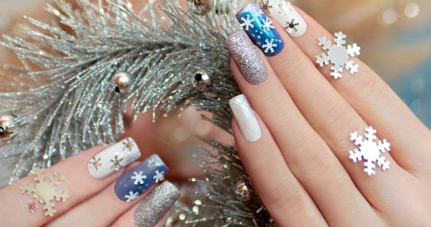 Someone showing off their holiday nail deisgn.