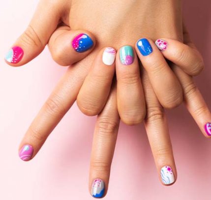 Summer nail trends 2020 Someone showing summer nail designs against a pink background.