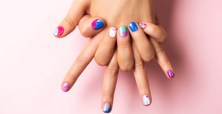 Someone showing summer nail designs against a pink background.