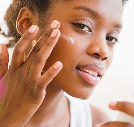 Best sun protection cream for face A woman applying SPF sun cream to her face.