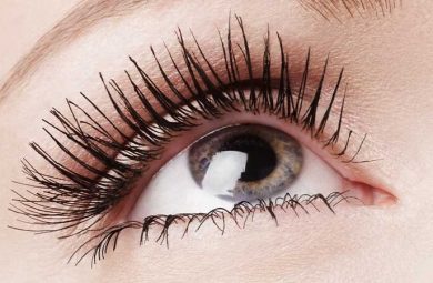 A close up photo of a person's eye and eye lashes wearing mascara