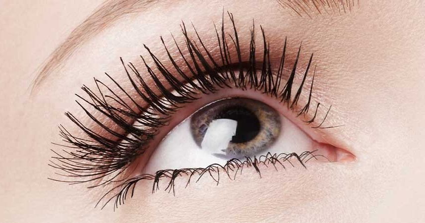 A close up photo of a person's eye and eye lashes wearing mascara