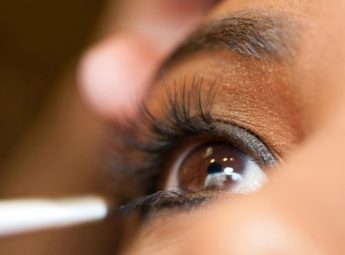 Applying makeup to a young woman using the key eye makeup essentials.